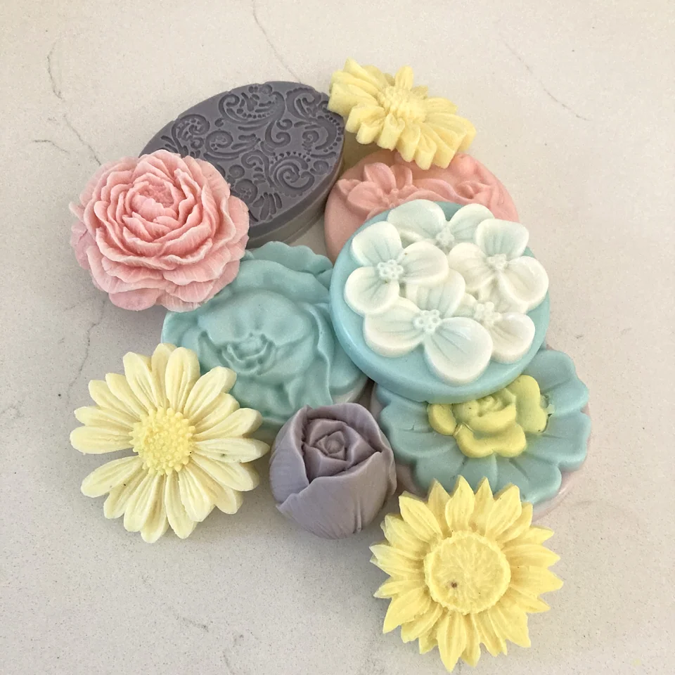 A colorful collection of pastel flower-shaped soaps